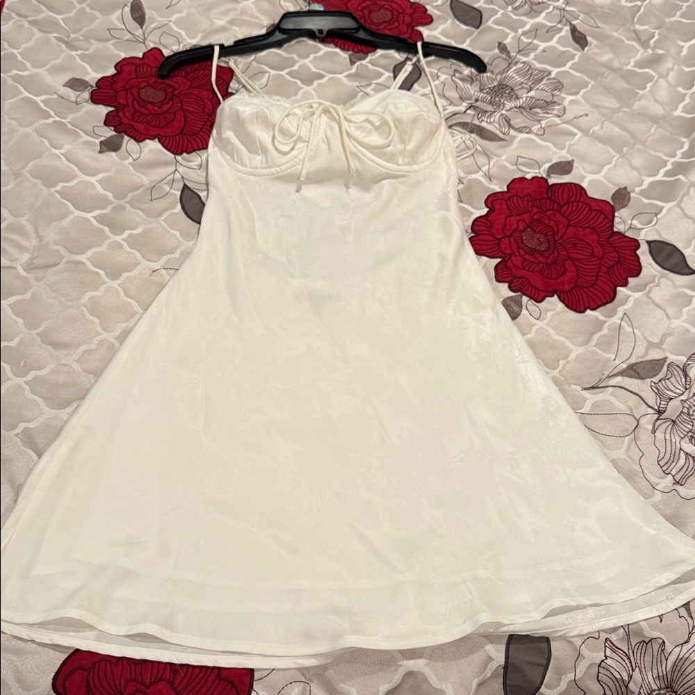 White, satin-finish, spaghetti strap slip dress.Floral embossed print